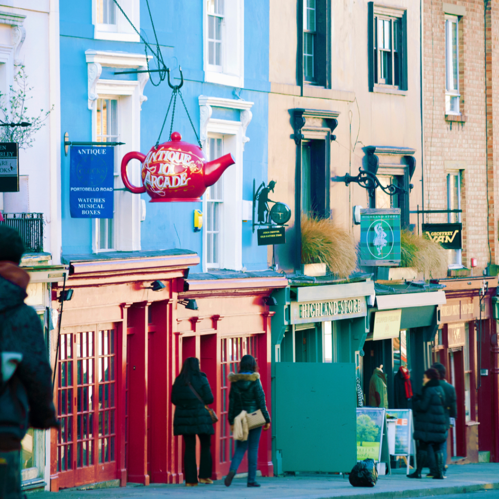 A brightly coloured (blue, red, green and yellow) row of shops in Notting Hill, London.